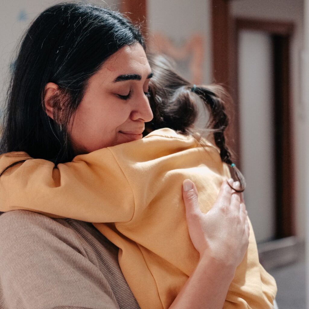 Woman hugging child