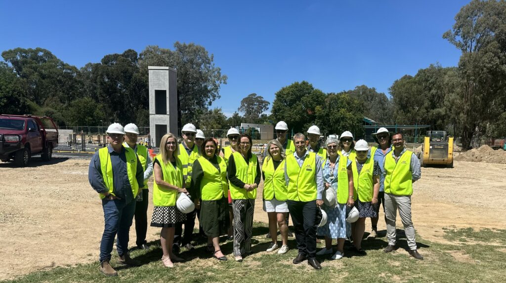 Group of people standing on site in high-vis